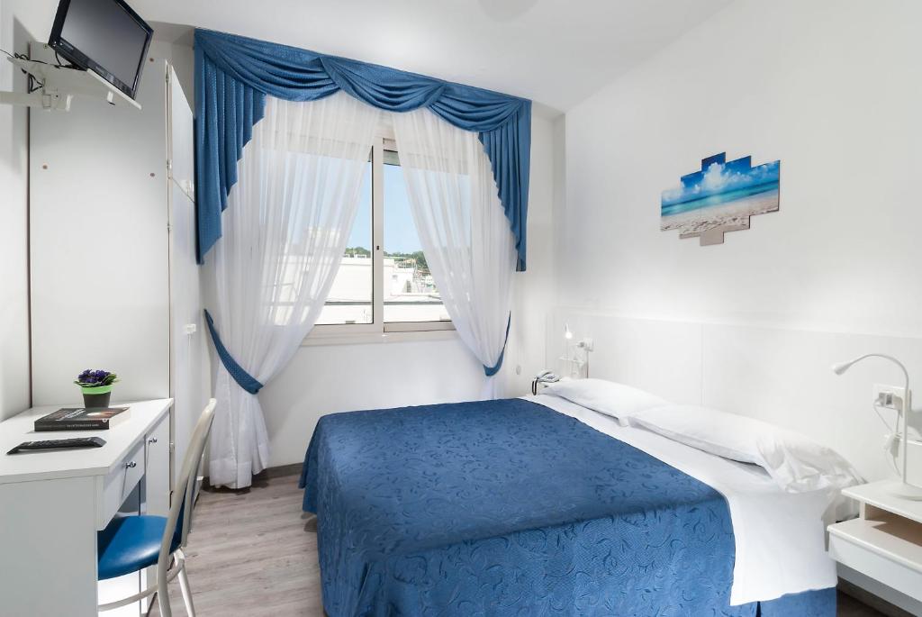 Postel nebo postele na pokoji v ubytování Hotel Lido