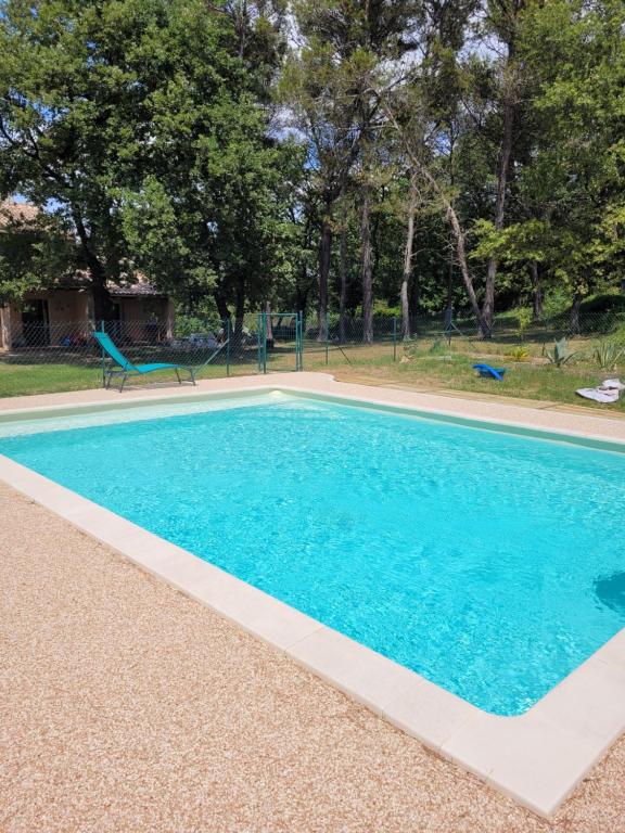 uma piscina com água azul num quintal em Calourasso em Mondragon