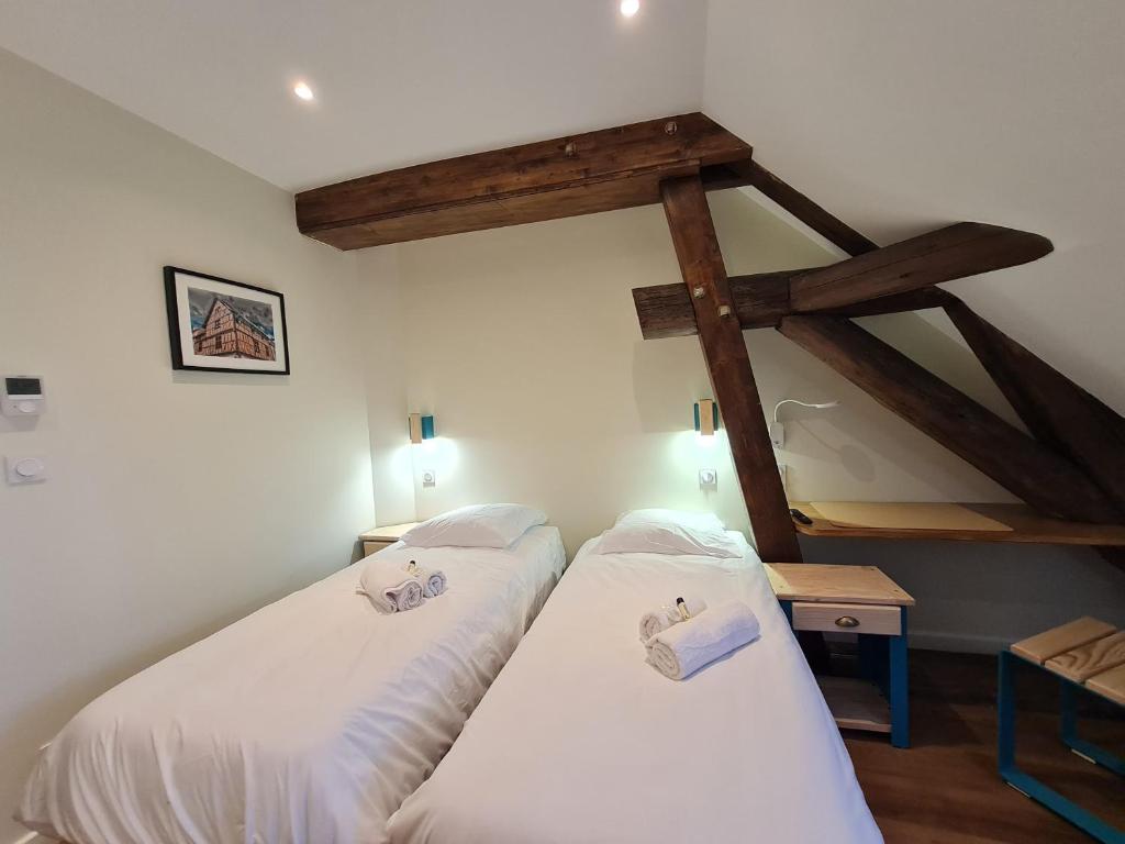 Postel nebo postele na pokoji v ubytování Le Faubourg - Gîte et chambres d'hôte