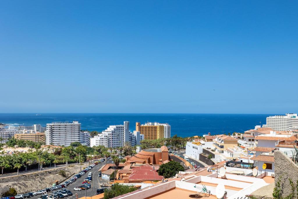 a view of a city with the ocean in the background at Ocean and Siam Park view Home by LoveTenerife in Adeje