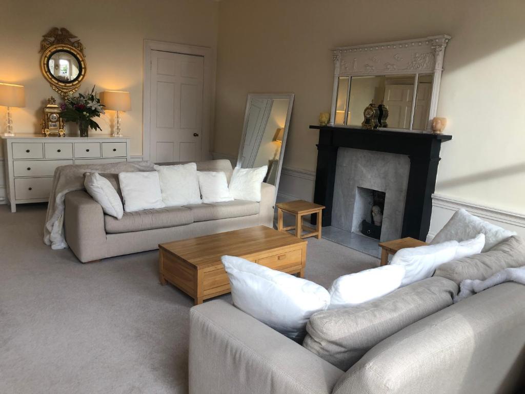 a living room with two couches and a fireplace at Beautiful Georgian New Town Flat in Edinburgh