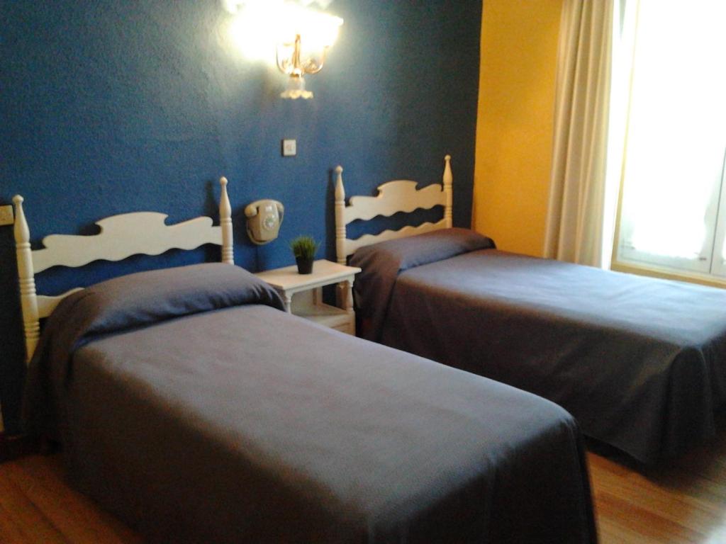 Łóżko lub łóżka w pokoju w obiekcie Hotel Luzon