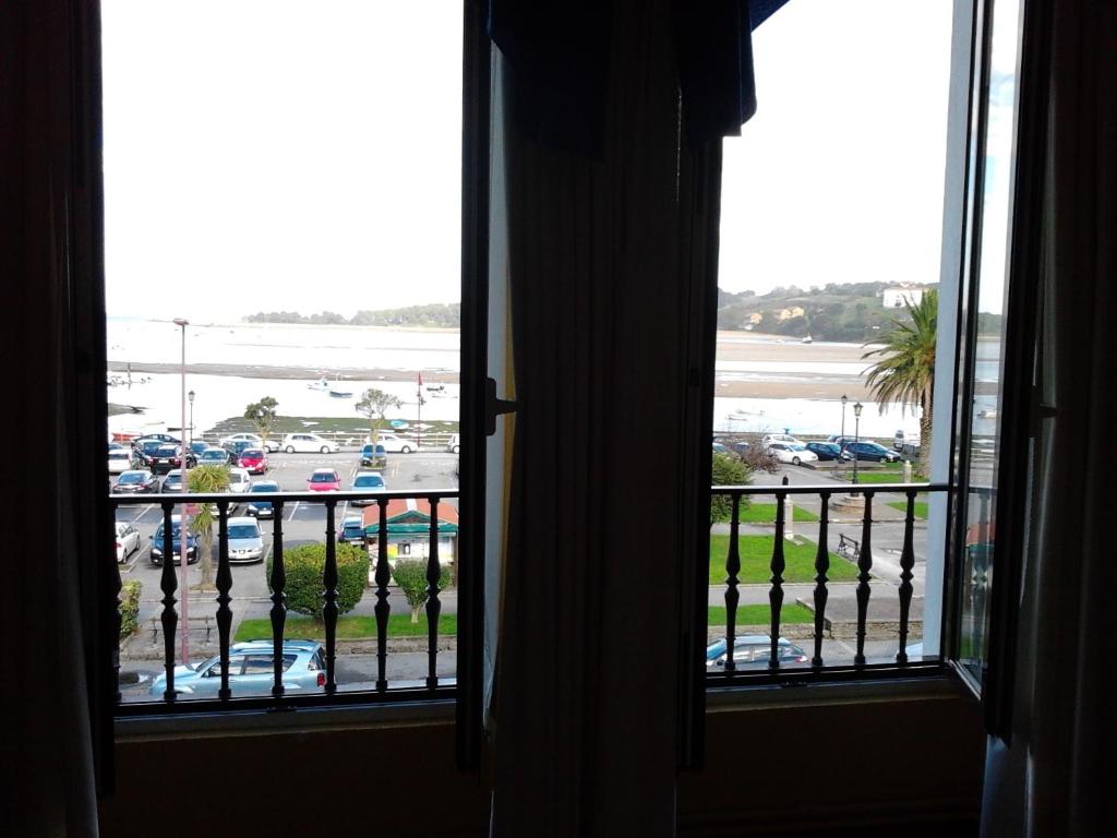 a room with a window looking out at a parking lot at Hotel Luzon in San Vicente de la Barquera
