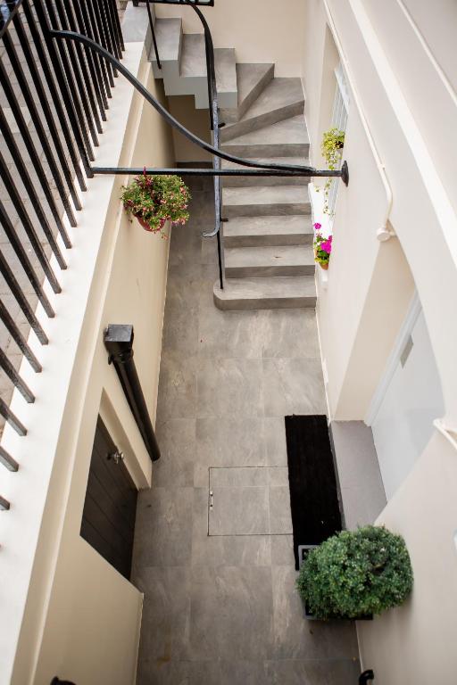 an overhead view of a staircase with potted plants at Marylebone Inn in London