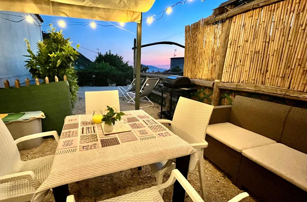 a table and chairs on a patio with an umbrella at The Dream in Massa Lubrense