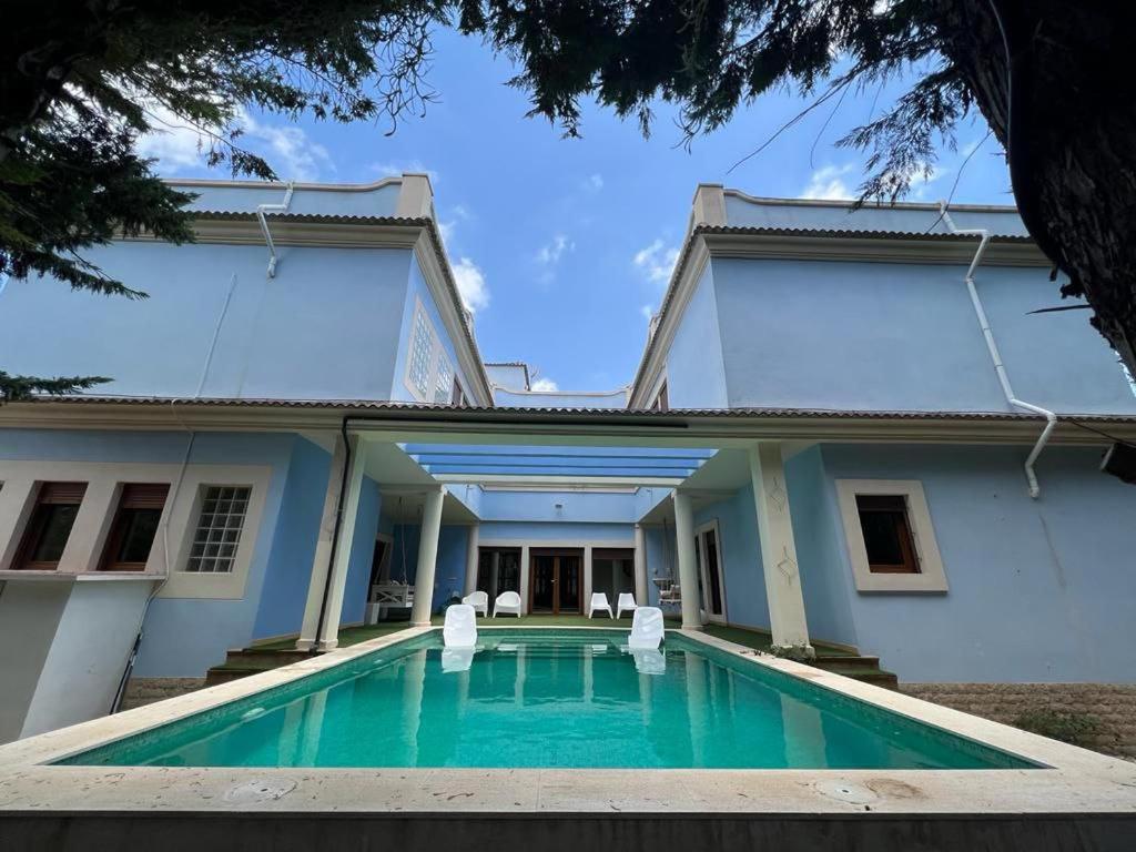 a house with a swimming pool in front of it at Villa Ca Toni in Alicante