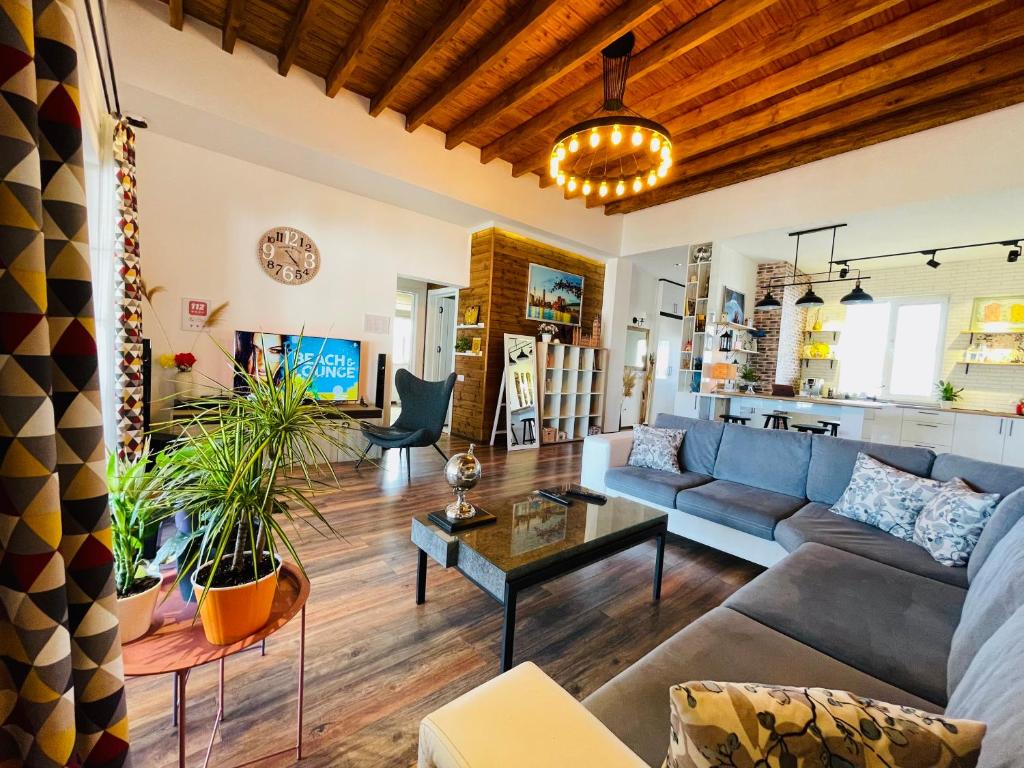 a living room with a couch and a table at Entire Villa in Saguramo - Near Tbilisi Nature Reserve in Mtskheta