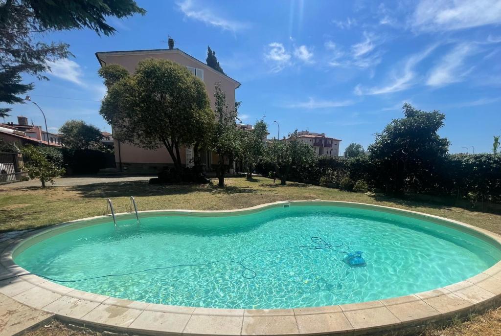a swimming pool in the yard of a house at Oceania apartments in Grosseto