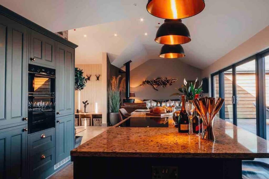 a kitchen with a large island in the middle of a room at The Lodge in Brecon