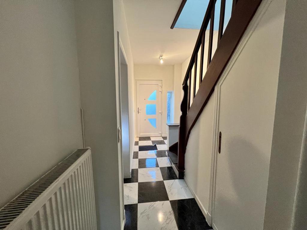 a hallway with a black and white checkered floor at Ganha holiday house in Antwerp