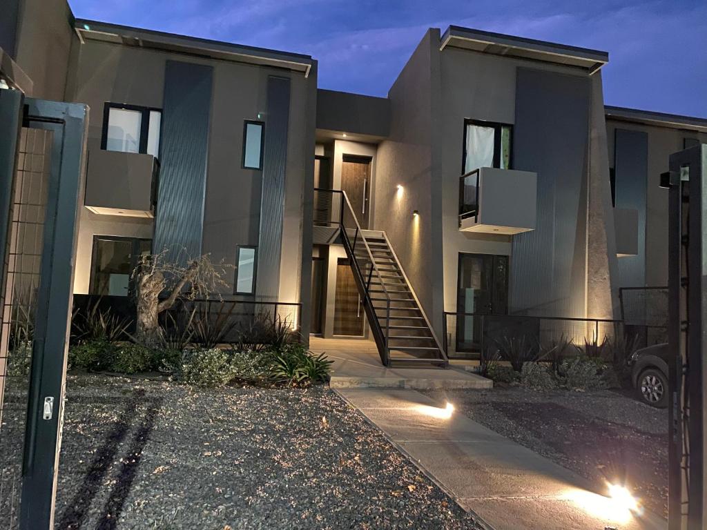 a house with a staircase in front of it at Moderno departamento ruta del vino en Bosques de Mayo in Maipú