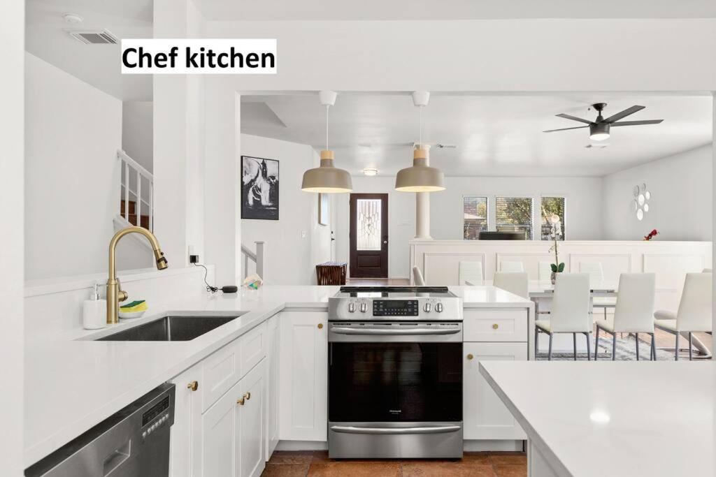 a white kitchen with a sink and a stove at 5 Bedrooms w/ Hot Tub, Chefs Kitchen, Game Lounge in San Antonio