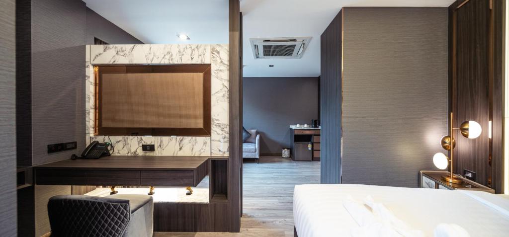 A compact built-in desk beside the bedroom, with a mirror and telephone.