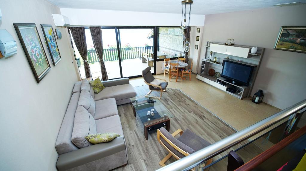 a living room with a couch and a table at Penev guest house in Glavatartsi