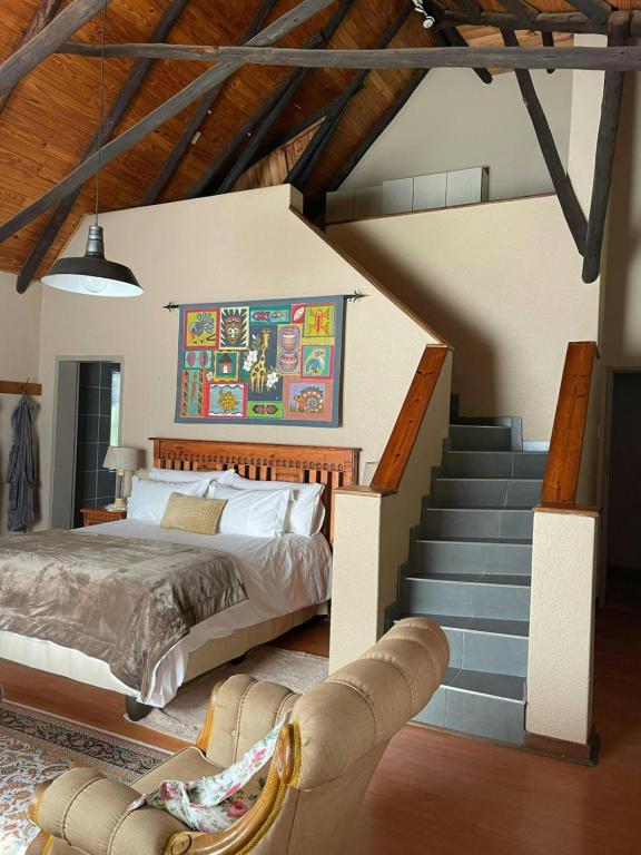 a bedroom with a bed and a staircase at Gerty's in Pretoria
