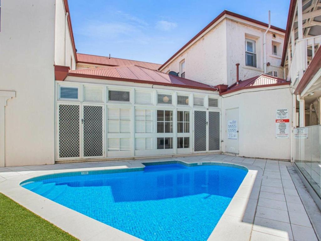 a swimming pool in front of a house at Centrally located Apt 22 - Smugglers Inn in Victor Harbor