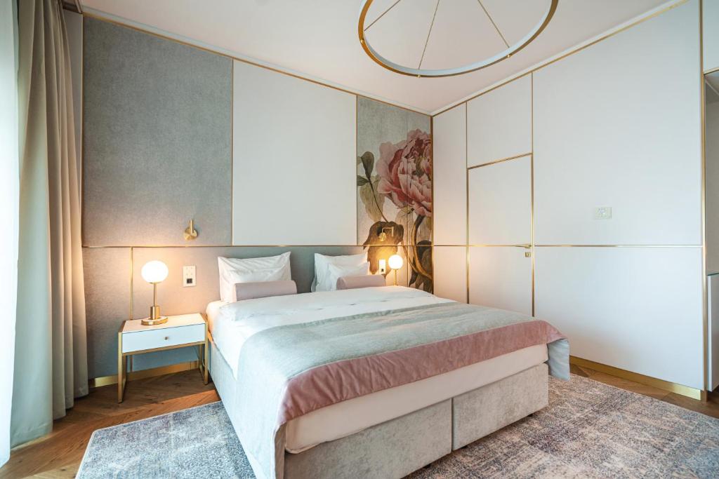a bedroom with a large bed and a chandelier at Hotel Ferreus Modern Art Deco in Krakow