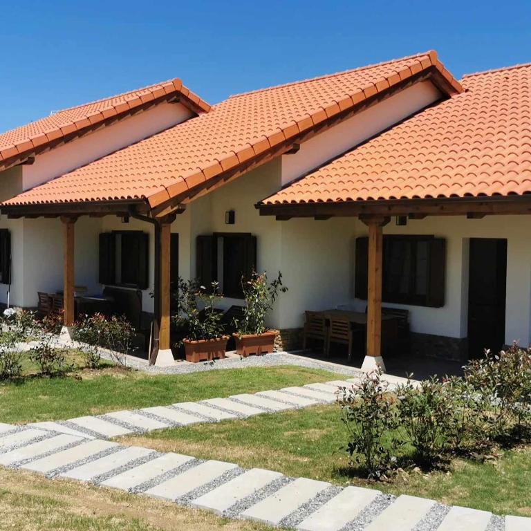 a house with an orange roof and a patio at La campa de Faedo-Tonin in Cudillero