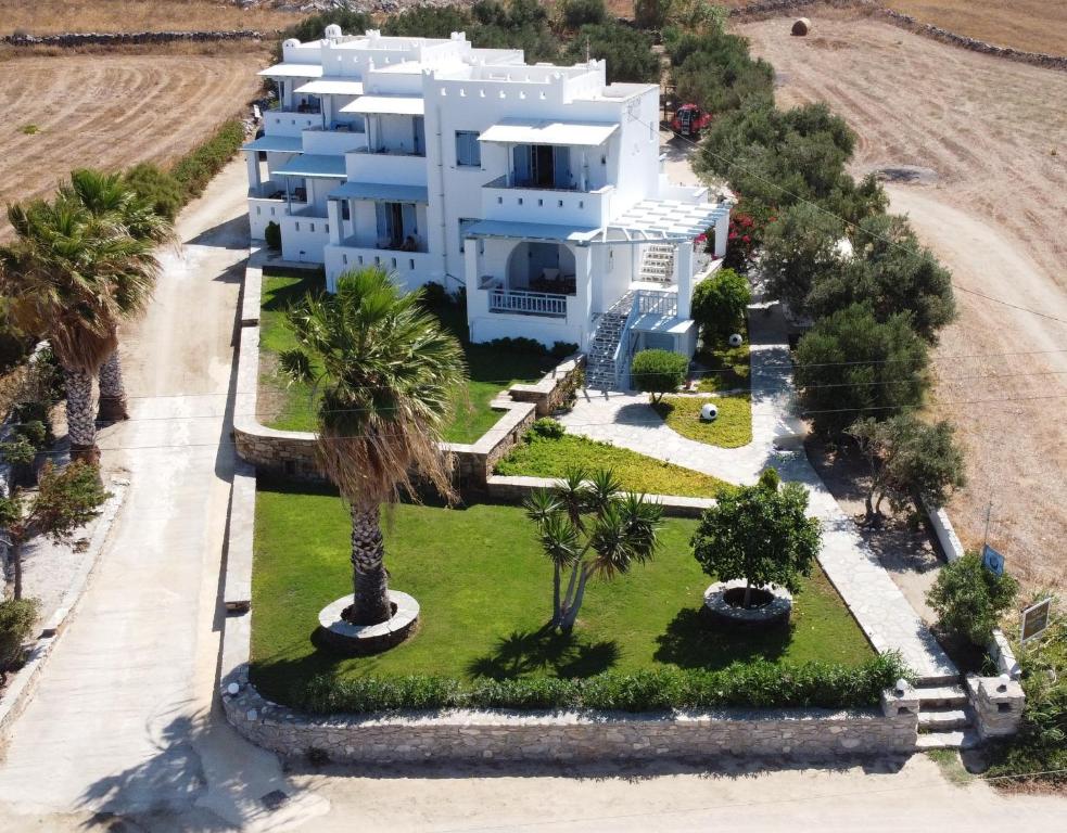 an aerial view of a white house with palm trees at Galini Studios in Mikri Vigla