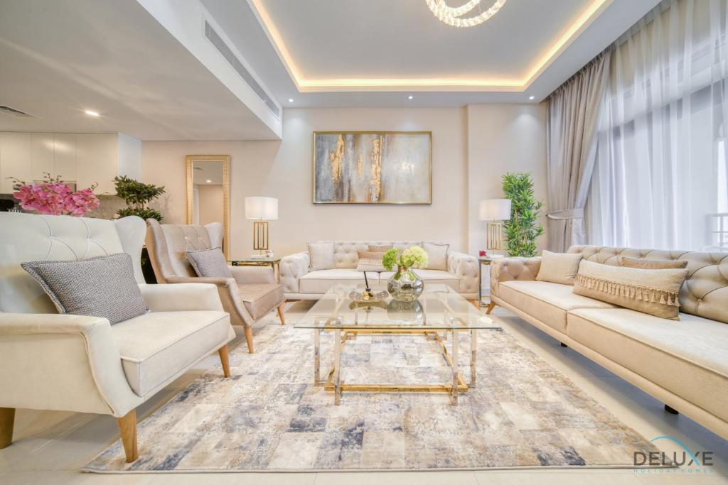 a living room with couches and a coffee table at Extravagant 1BR At Madinat Jumeirah Living Rahaal 2 by Deluxe Holiday Homes in Dubai