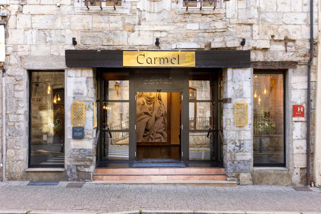 een kamelenwinkel met een standbeeld voor een gebouw bij Carmel 1643 in Arbois
