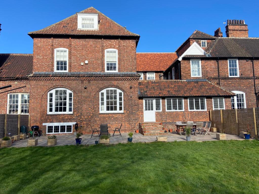 a large brick building with a lawn in front of it at Red Barns Bed & Breakfast in Redcar