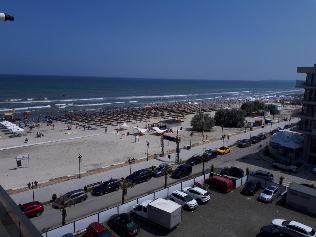 a parking lot next to a beach with cars parked at Luxury New and Modern Apartments in Mamaia Nord
