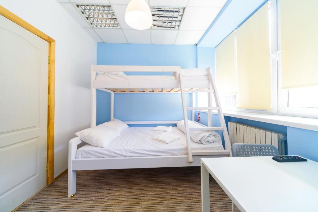 a bunk bed in a room with a window at Traveler's haven in Odesa