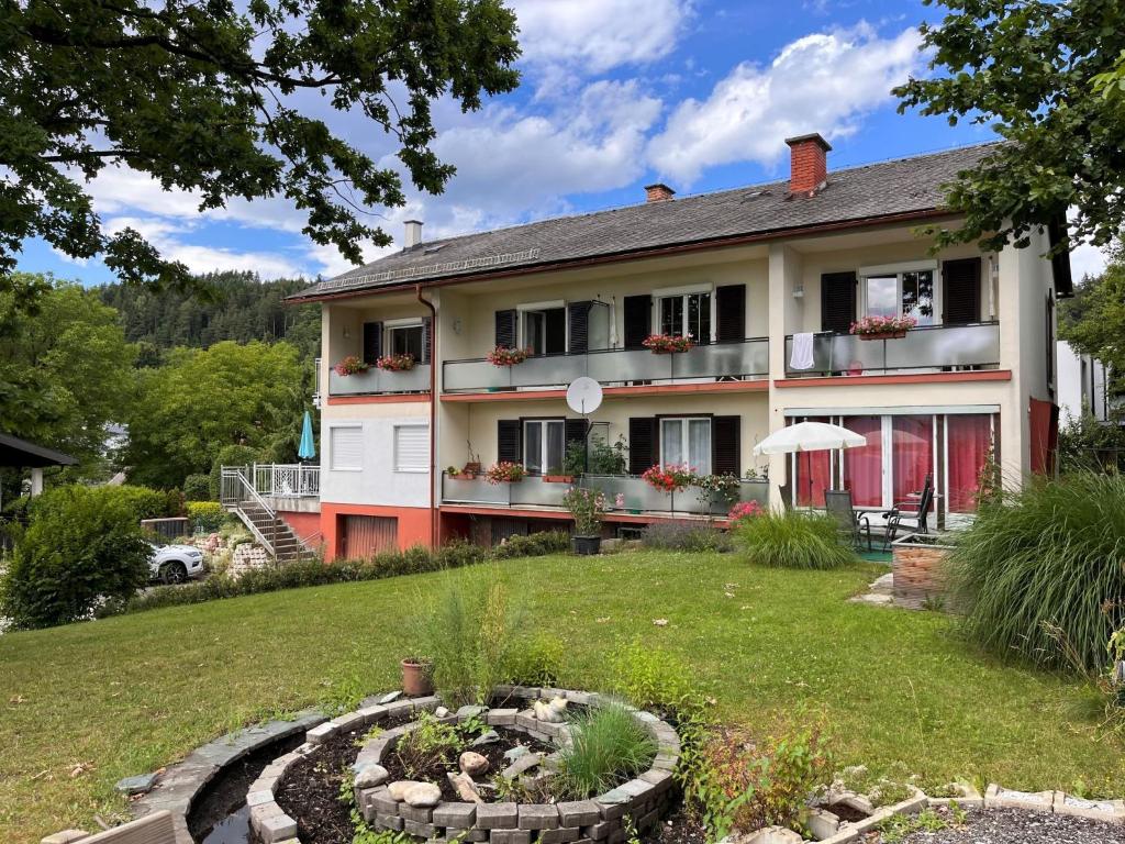 a house with a garden in front of it at Apartment Meran - PTS120 by Interhome in Görtschach