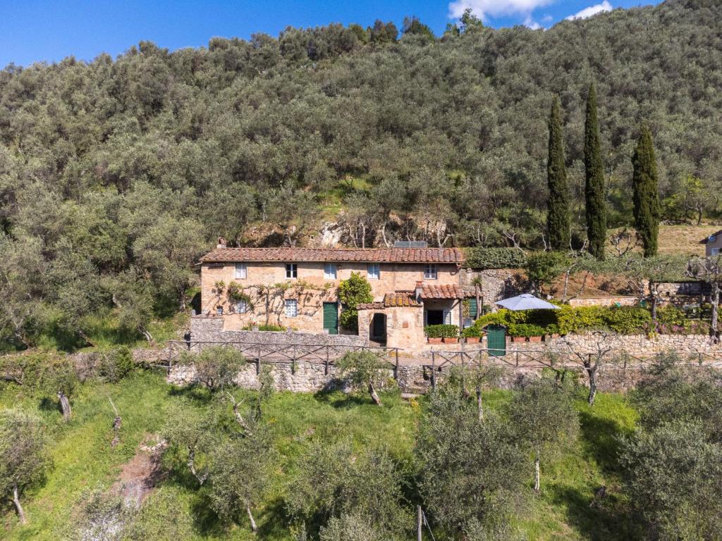 an old stone house on a hill with trees at Holiday Home Il Metatino by Interhome in Montemagno
