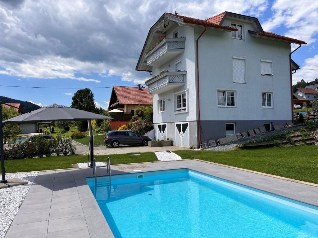 a house with a swimming pool in front of a house at Apartment Frank-1 by Interhome in Feldkirchen in Kärnten