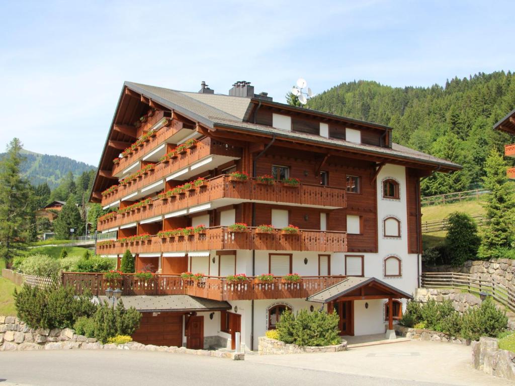 a large building with balconies on the side of it at Apartment Rhodonite 33 by Interhome in Villars-sur-Ollon