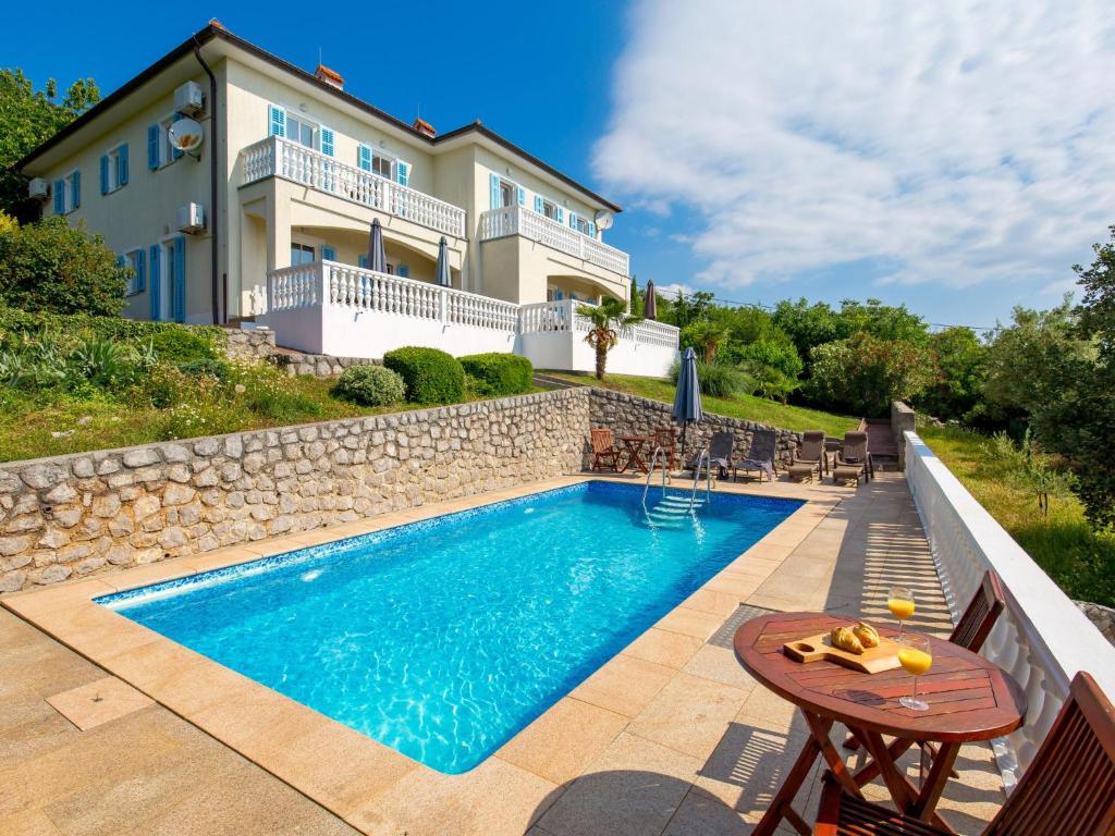 a swimming pool in front of a house at Holiday Home Casa Albertina-2 by Interhome in Martina