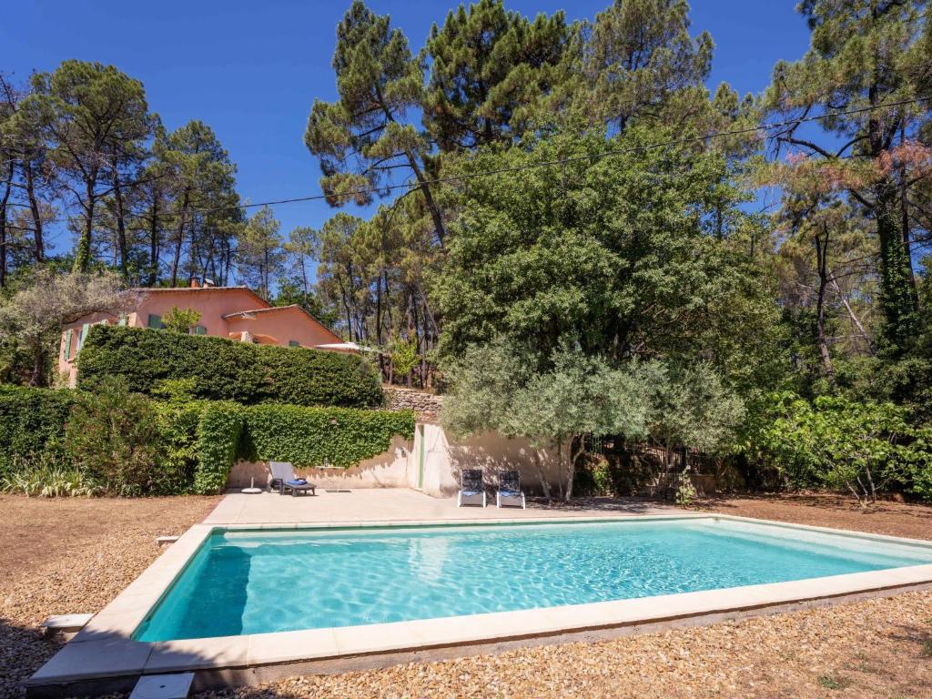 a swimming pool in the yard of a house at Holiday Home Les Ecureuils by Interhome in Saint-Pantaléon
