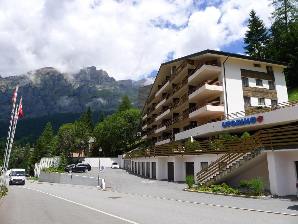 a building on the side of a road with a mountain at Apartment Ringstrasse - Utoring-42 by Interhome in Leukerbad
