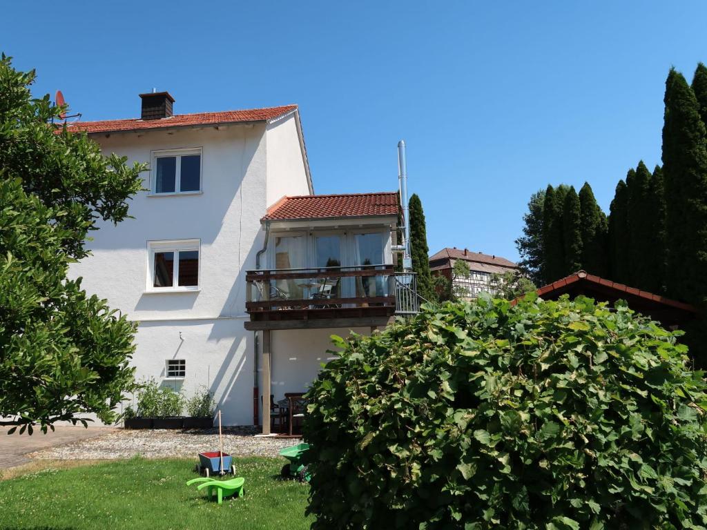 a white house with a balcony and a yard at Apartment Petra by Interhome in Nentershausen