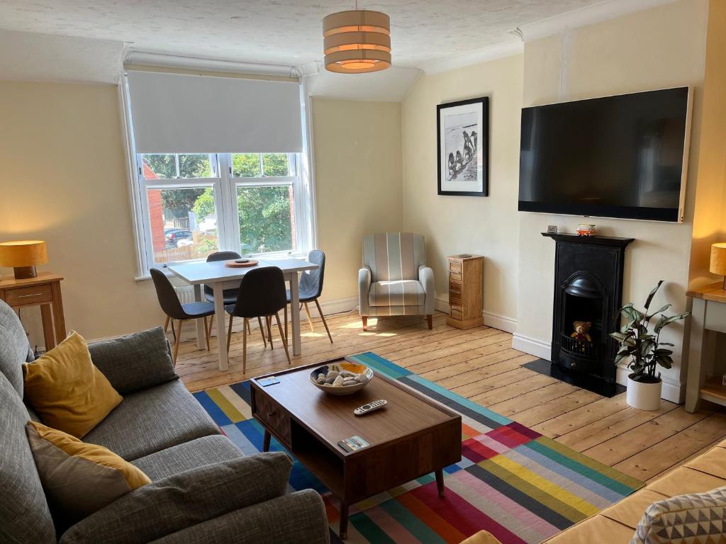 a living room with a couch and a table at Stunning 1-Bed Apartment in Sheringham in Sheringham