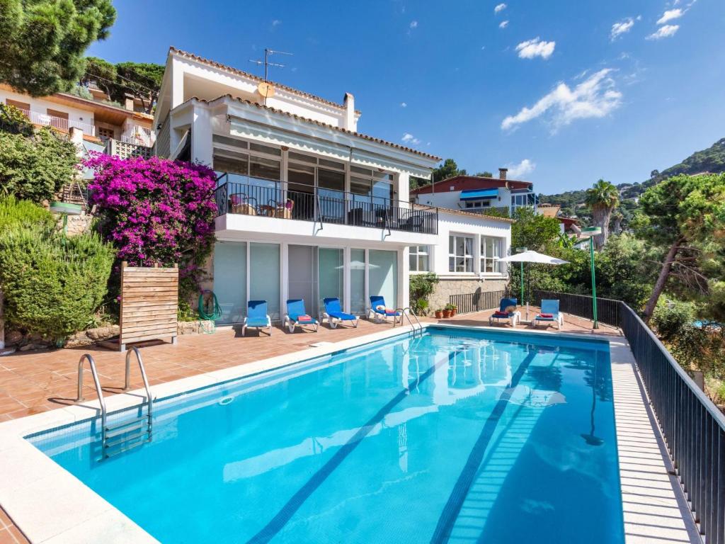 a swimming pool in front of a house at Holiday Home Balmain by Interhome in Lloret de Mar