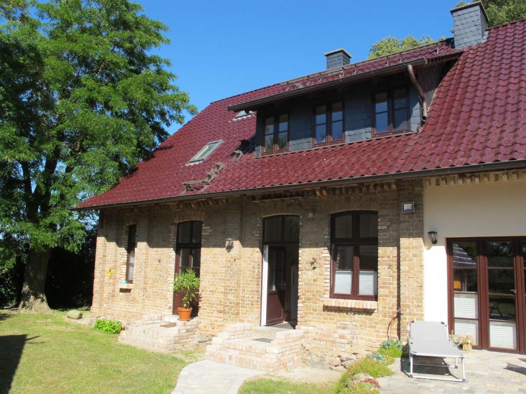 an old brick house with a red roof at Apartment Helene by Interhome in Ribnitz-Damgarten