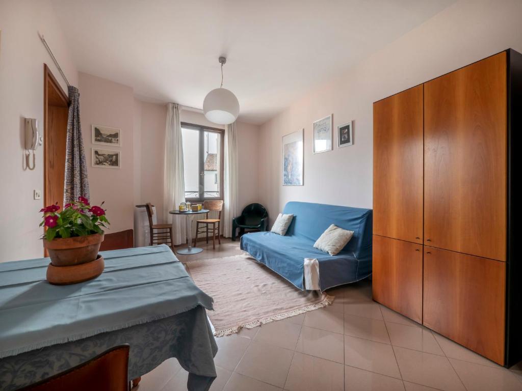 a living room with a blue couch and a table at Apartment Squisleep-2 by Interhome in San Daniele del Friuli