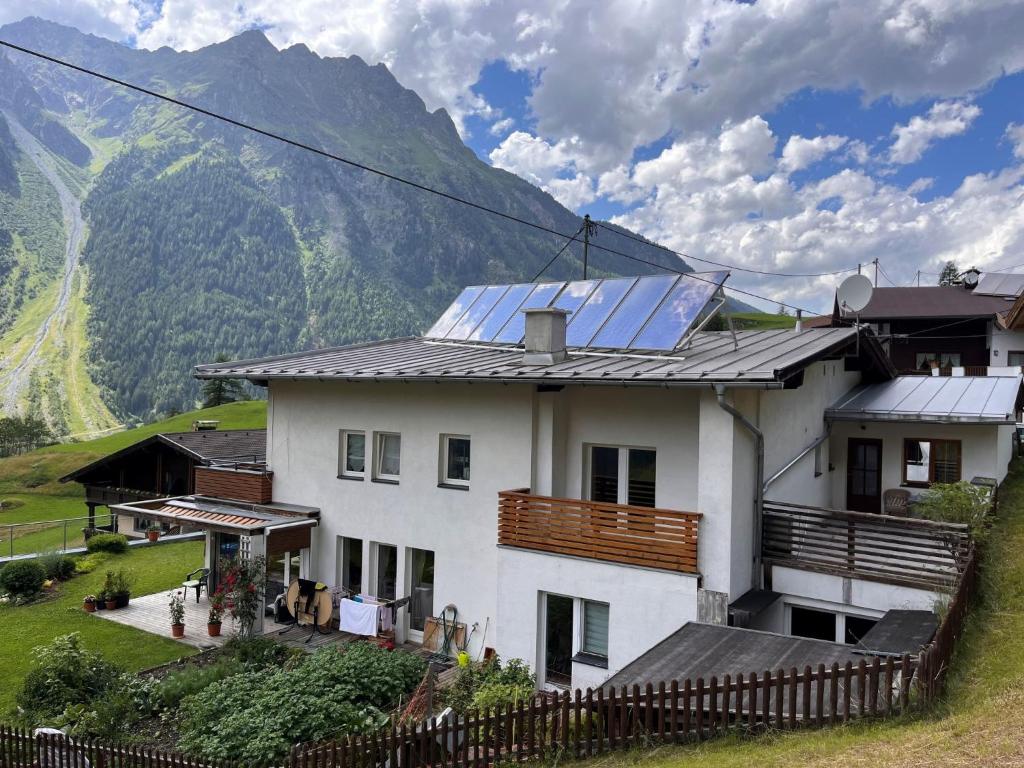 a house with solar panels on the roof at Apartment Aktiv by Interhome in Huben