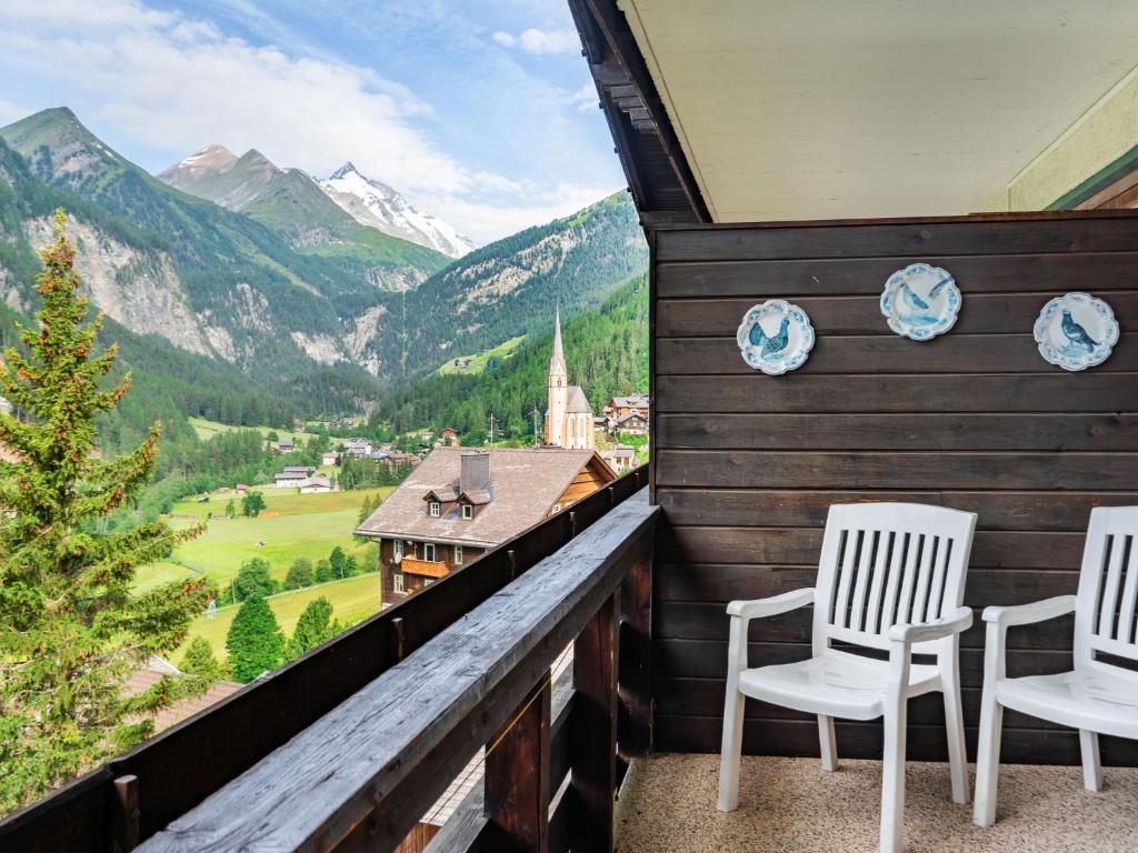 two chairs on a balcony with a view of mountains at Apartment Top 49 by Interhome in Heiligenblut