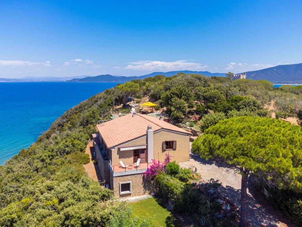 an aerial view of a house on a hill next to the ocean at Villa Villa Giuliana by Interhome in Punta Ala