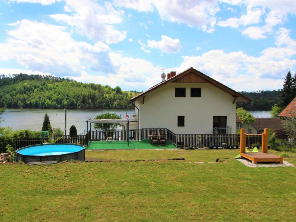 a house with a pool in the yard next to a building at Apartment Županovice-2 by Interhome in Dobříš