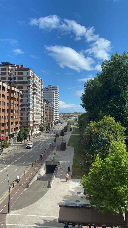 a view of a city with a street and buildings at Playa San Lorenzo-Estadio Sporting in Gijón