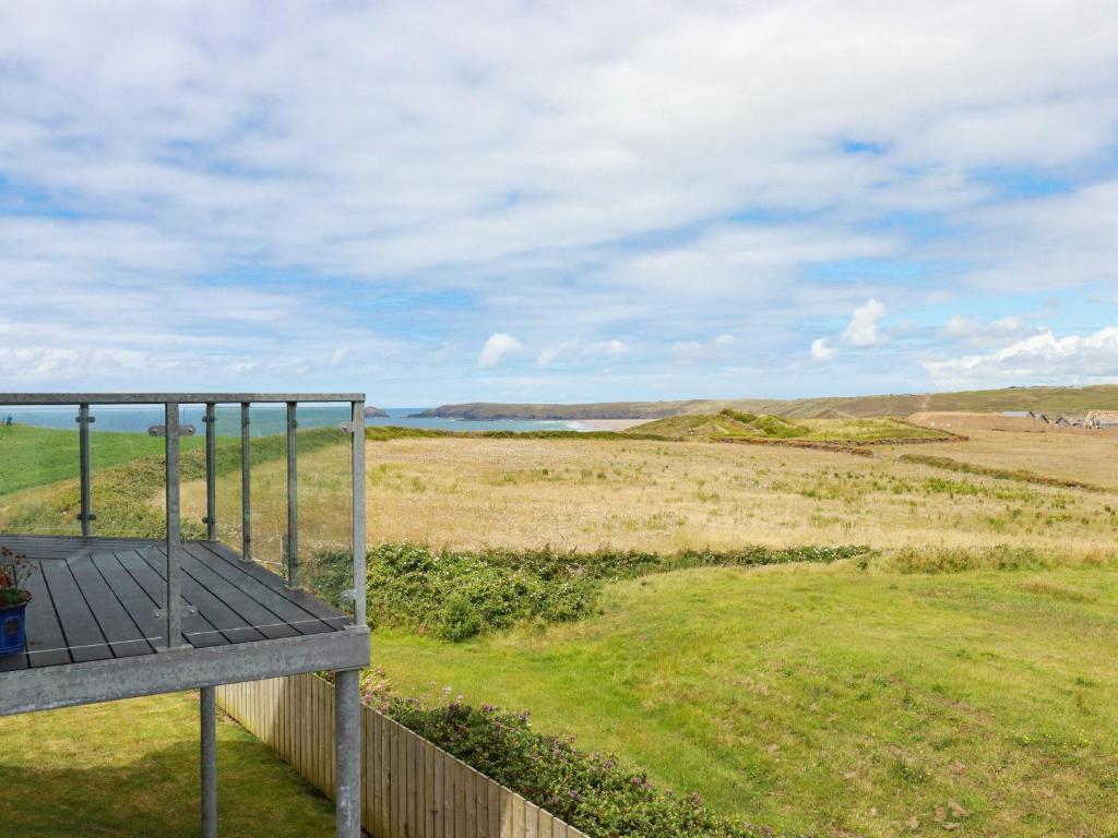 a view of a field from the balcony of a house at Sandpiper in Perranporth