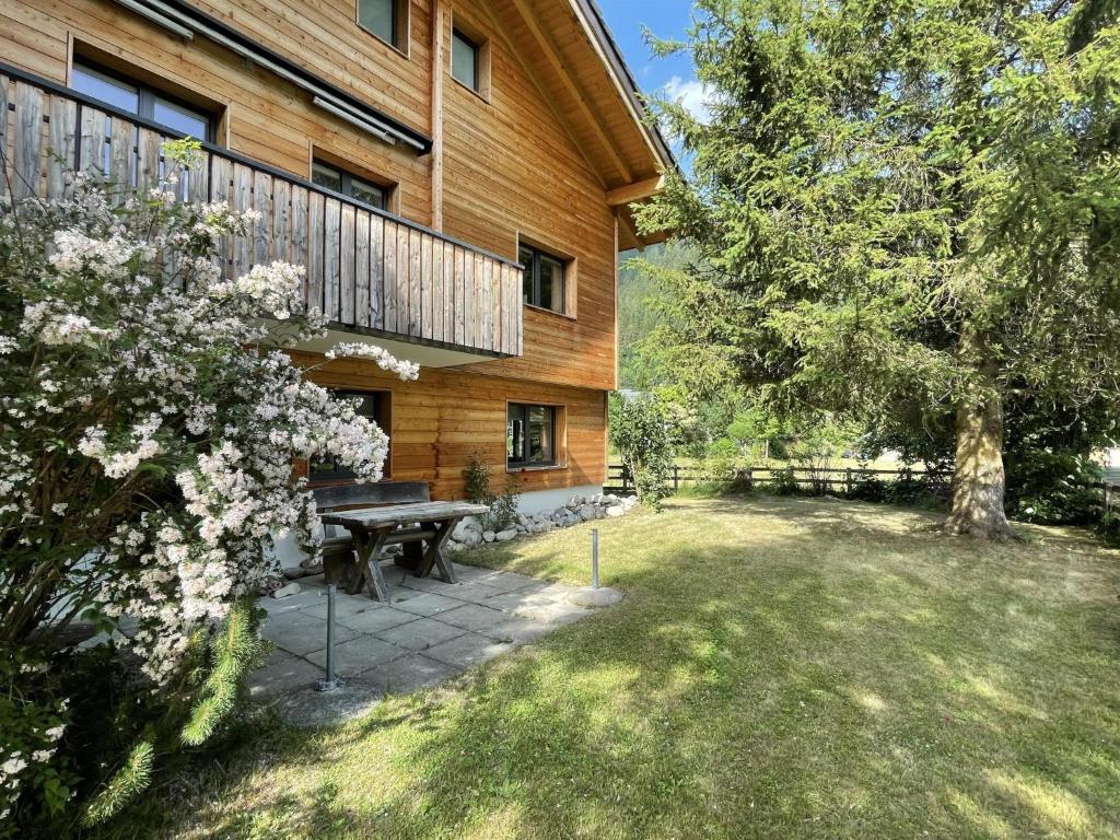a picnic table in a yard next to a building at Apartment Ilse EG by Interhome in Fieschertal