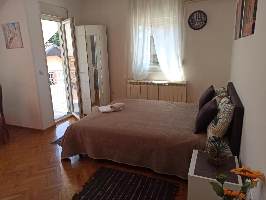 a bedroom with a bed and a large window at Cozy studio Belgrade (Zemun) in Belgrade