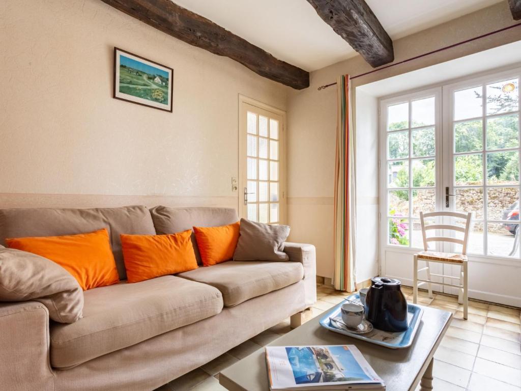 a living room with a couch and a table at Holiday Home La Vallée by Interhome in Cancale