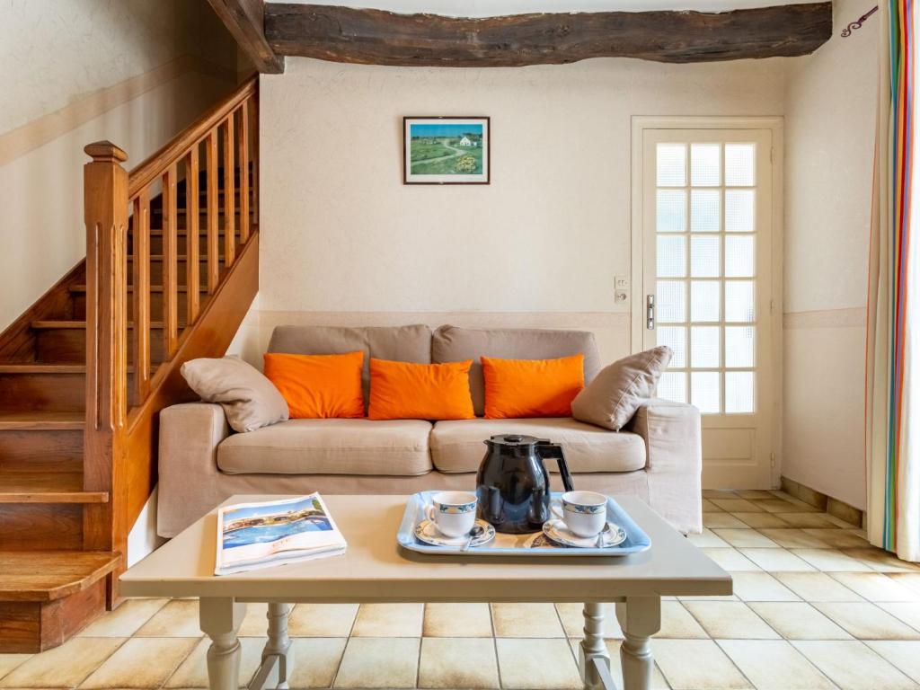 a living room with a couch and a table at Holiday Home La Vallée by Interhome in Cancale